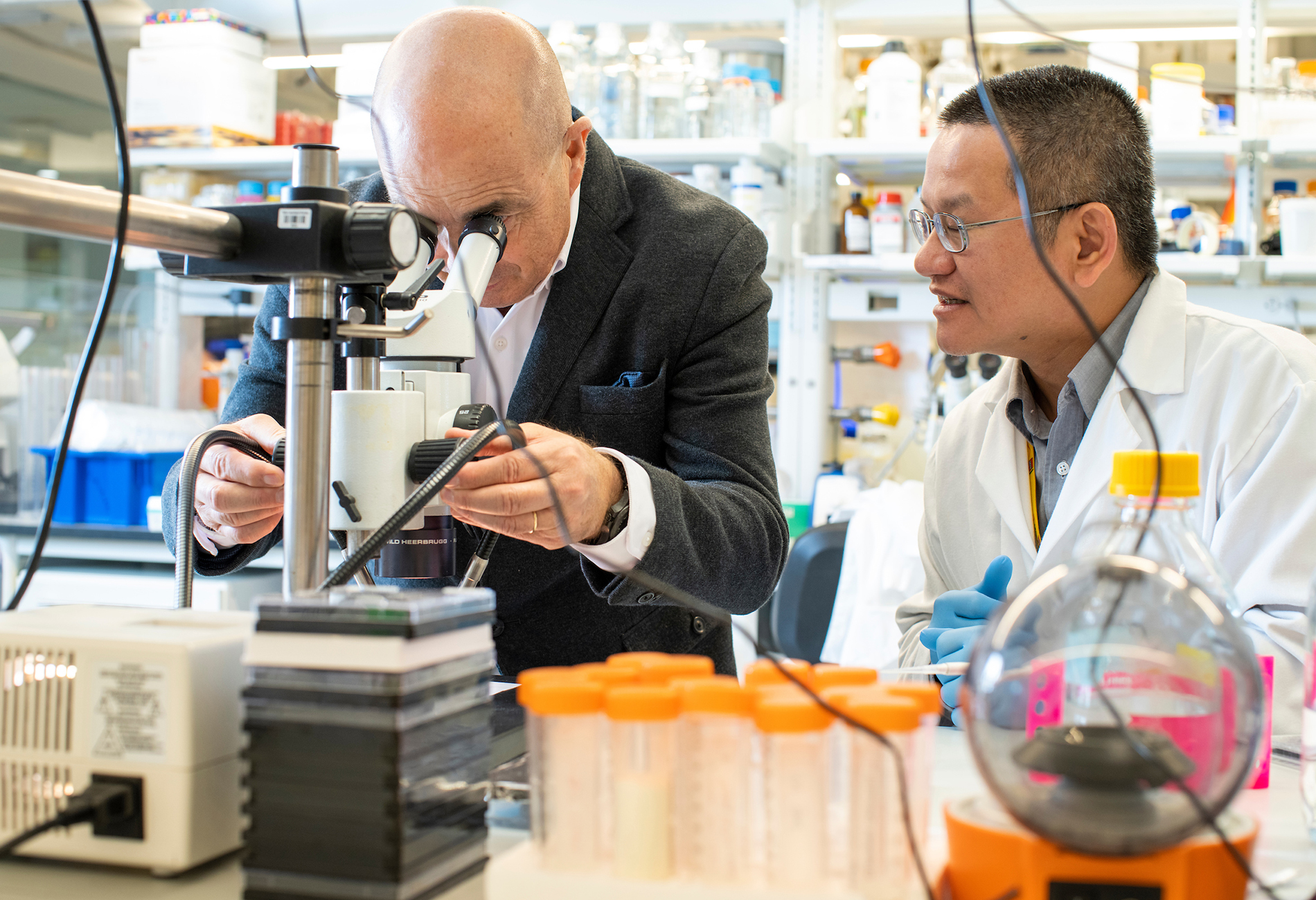 Jeremy Levin, chief executive officer of Ovid Therapeutics, looks through a microscope at slices of a mouse brain with scientist Shing Hong Lin in the company’s lab at Tufts Launchpad Biolabs in Boston, Massachusetts.
