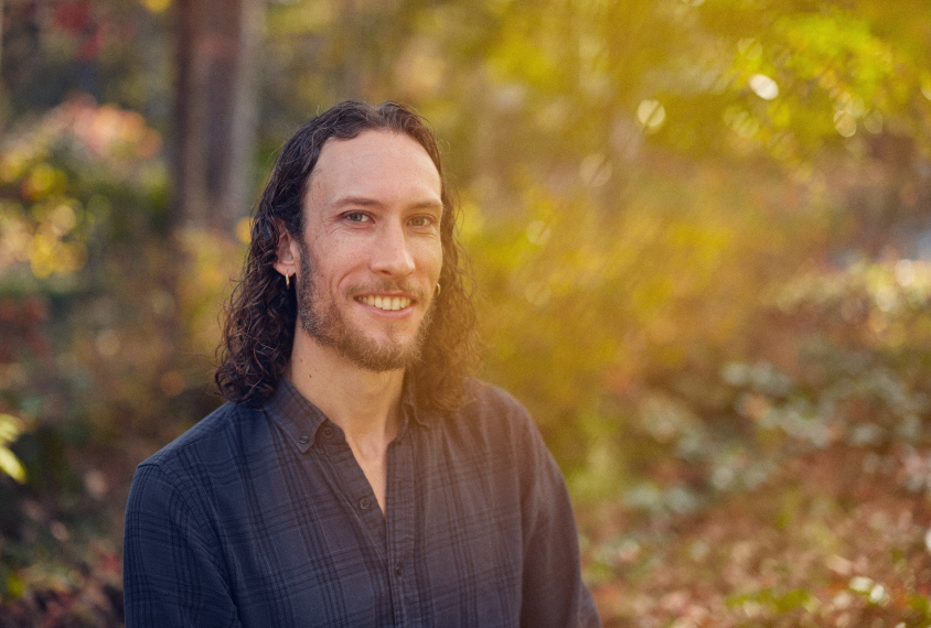 Graham Diering smiles in a portrait in his yard.