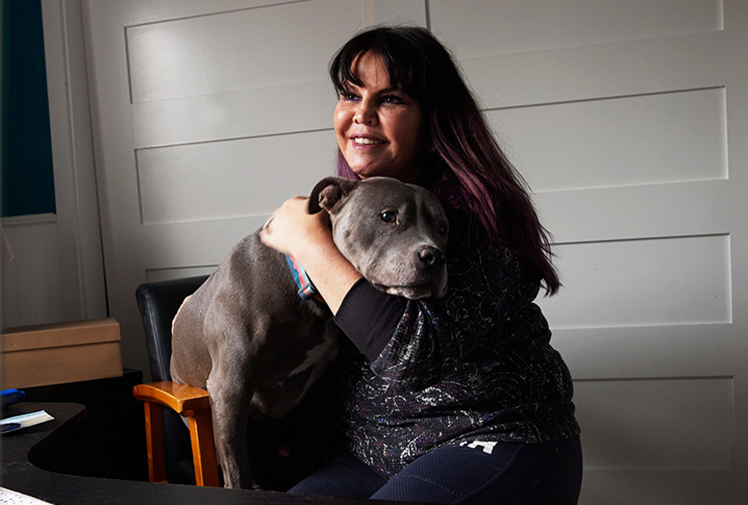 Jill Silverman sits at her desk with her dog.