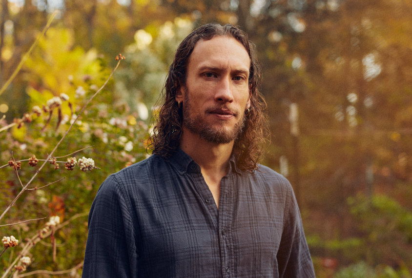 Graham Diering stands outside in a garden.