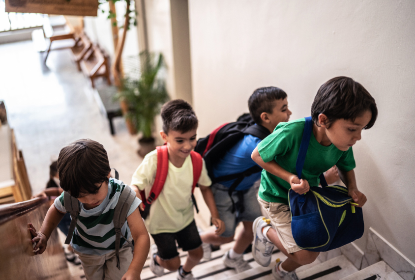 A group of children walk up stairs