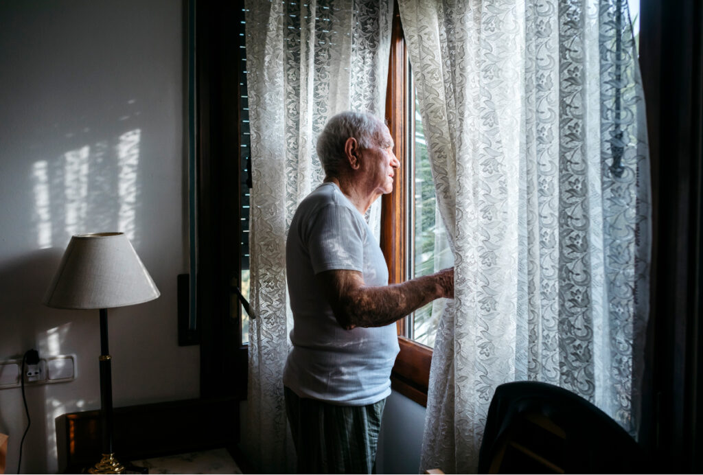 A man looks out the window