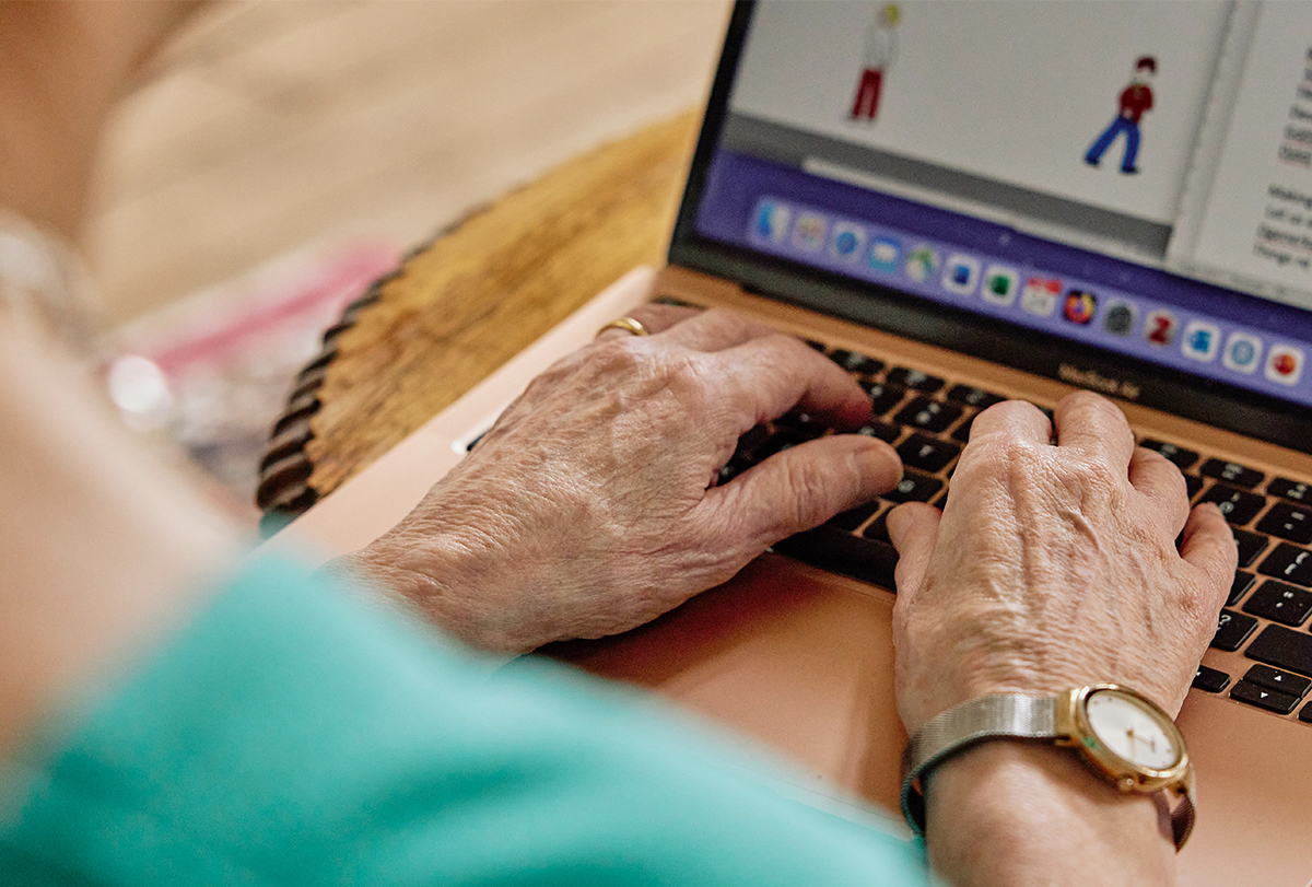 Close-up photograph of Dorothy Bishop typing on a laptop.