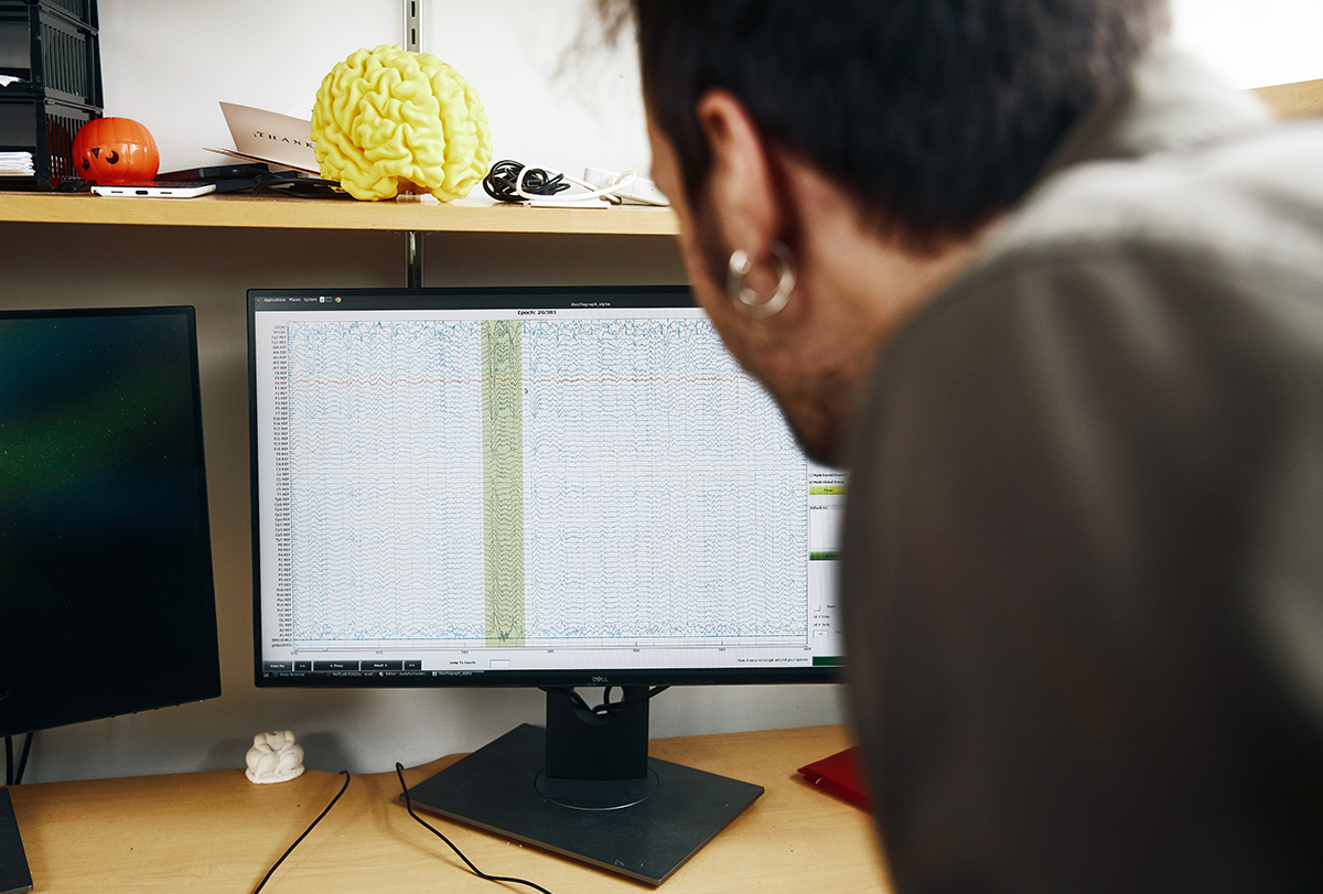 Dimitrios Mylonas examines sleep data on a computer monitor.