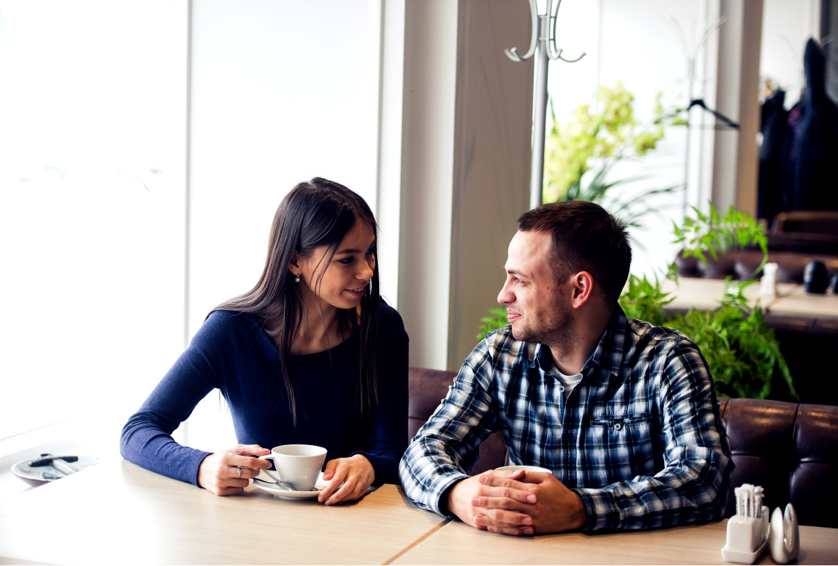 A couple drinks tea at a café.