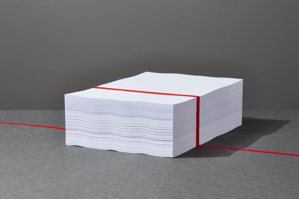 An illustration of a stack of papers with a red line running through them