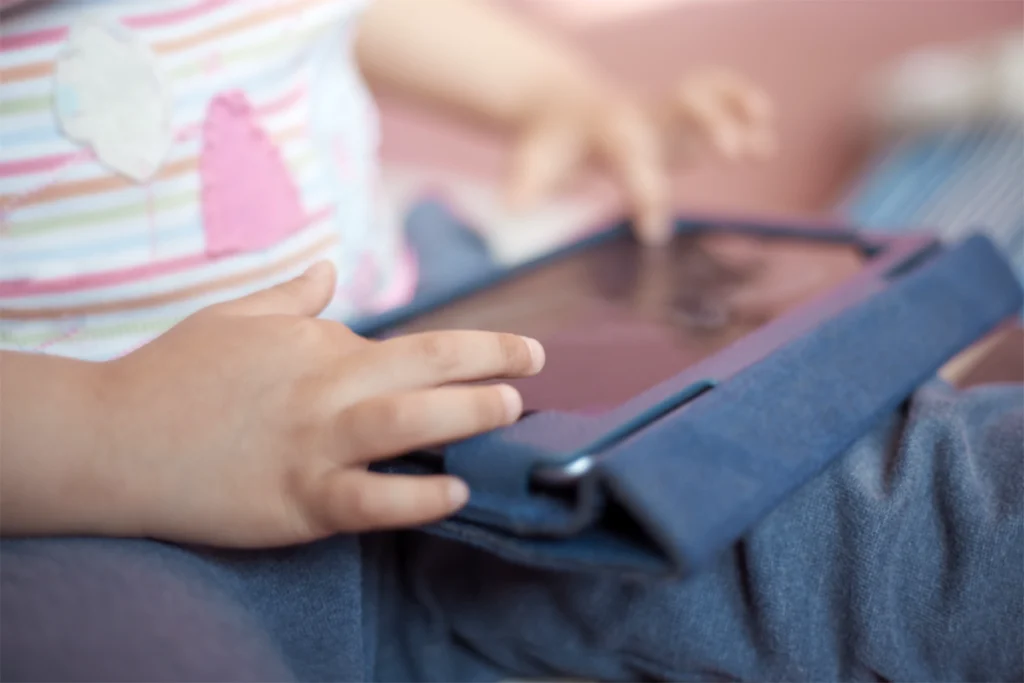 A child uses a tablet device