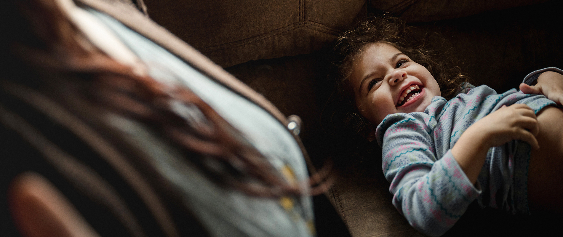 Coraline smiles at her mother in a moment of play at home.