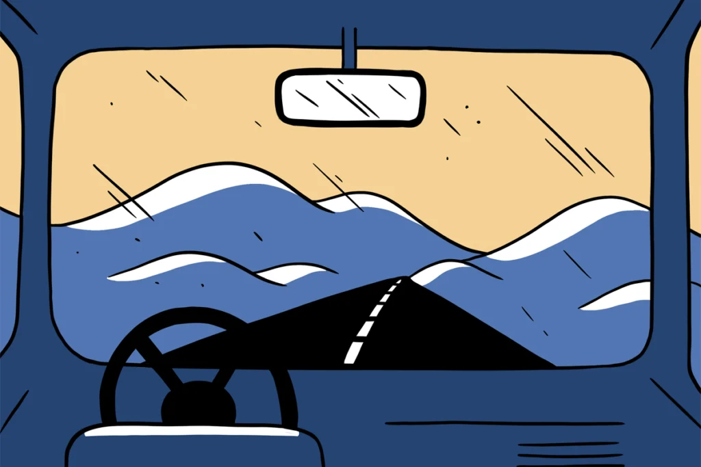 A car drives on a mountainous highway