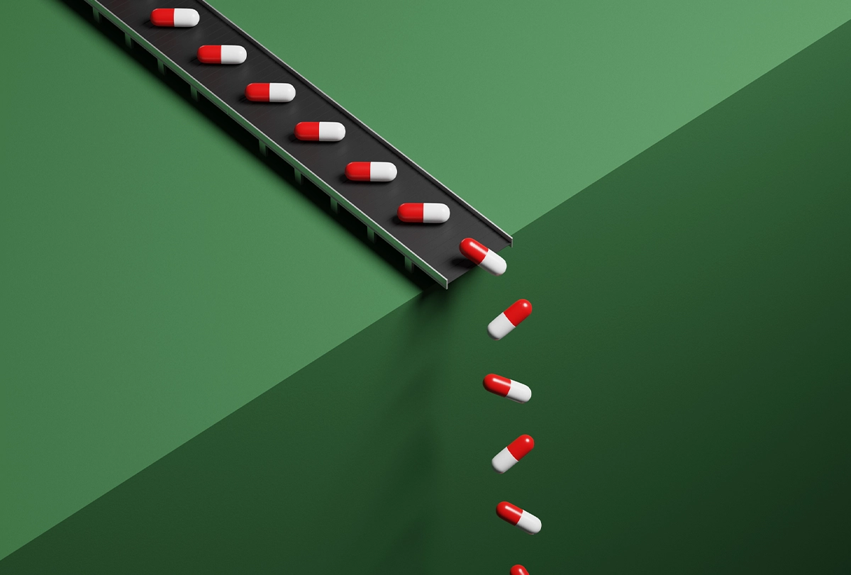 Illustration of a conveyor belt spilling pills over a green cliff face.