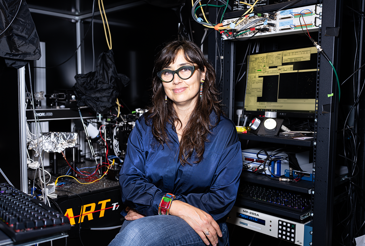 Eugenia Chiappe sits in front of technical equipment in her lab.