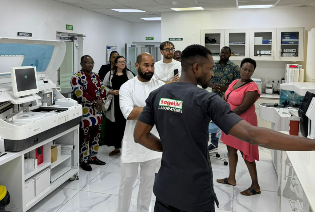 Photograph of the BRIDGE team and students visiting a laboratory.