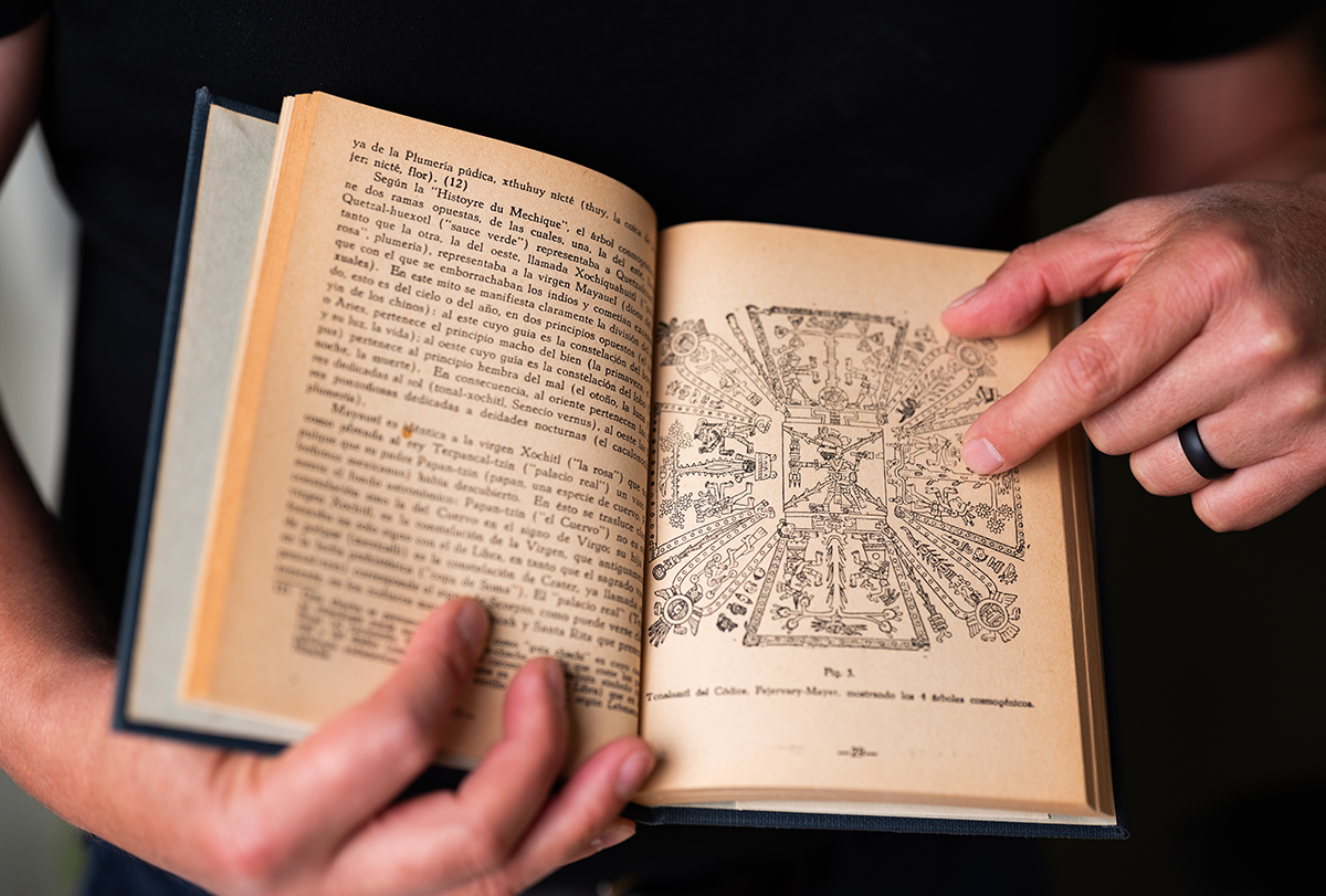 The scientist holding a rare book, Mitobonatica Zapoteca.