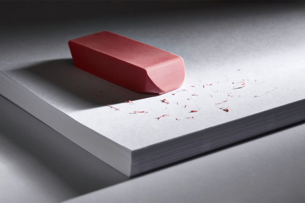 Eraser sitting on a stack of papers.
