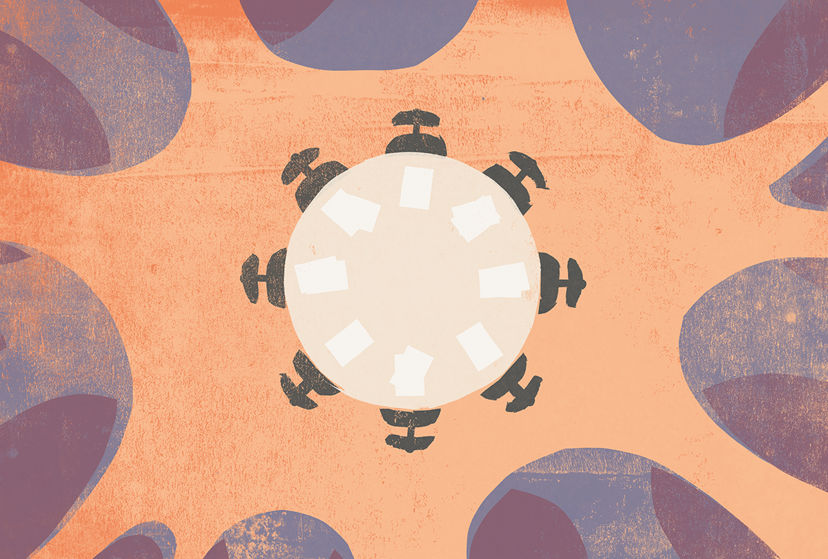 Round conference table with empty chairs around it, seen from above.