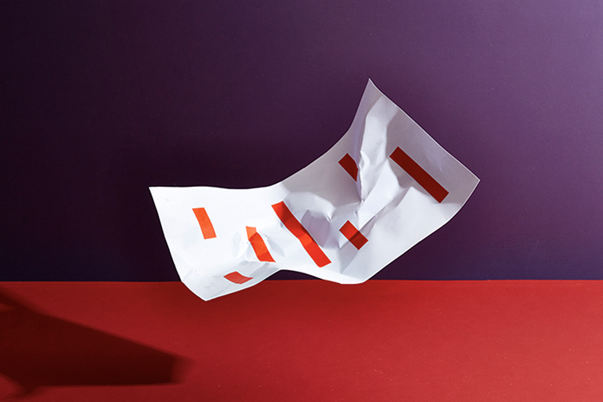 Wrinkled sheet of paper with multiple red rectangles printed on it.