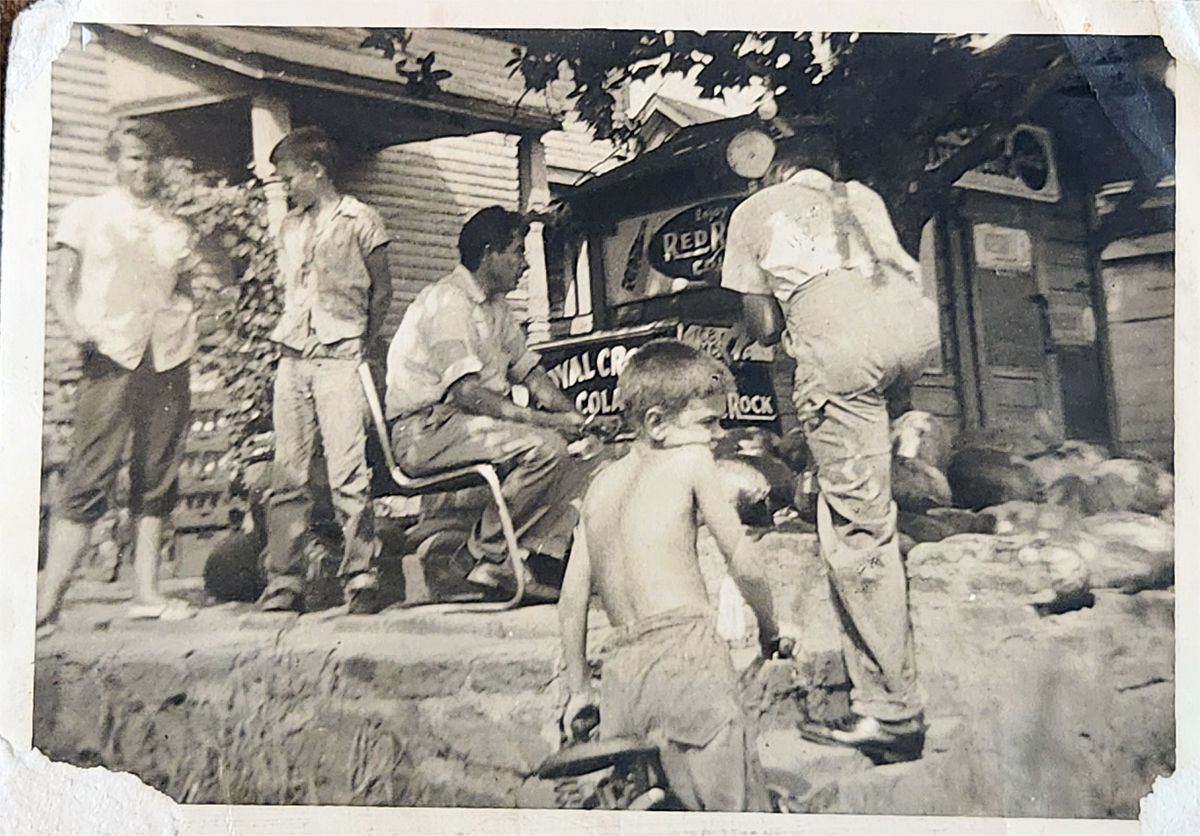 Photograph of Terry McDonald as a child outdoors with a group of young boys.