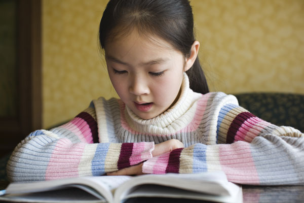 Young girl reading a book